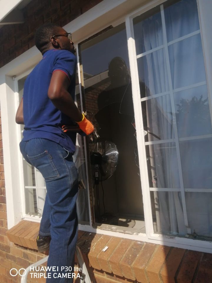 A fitter working on the glass in a window frame