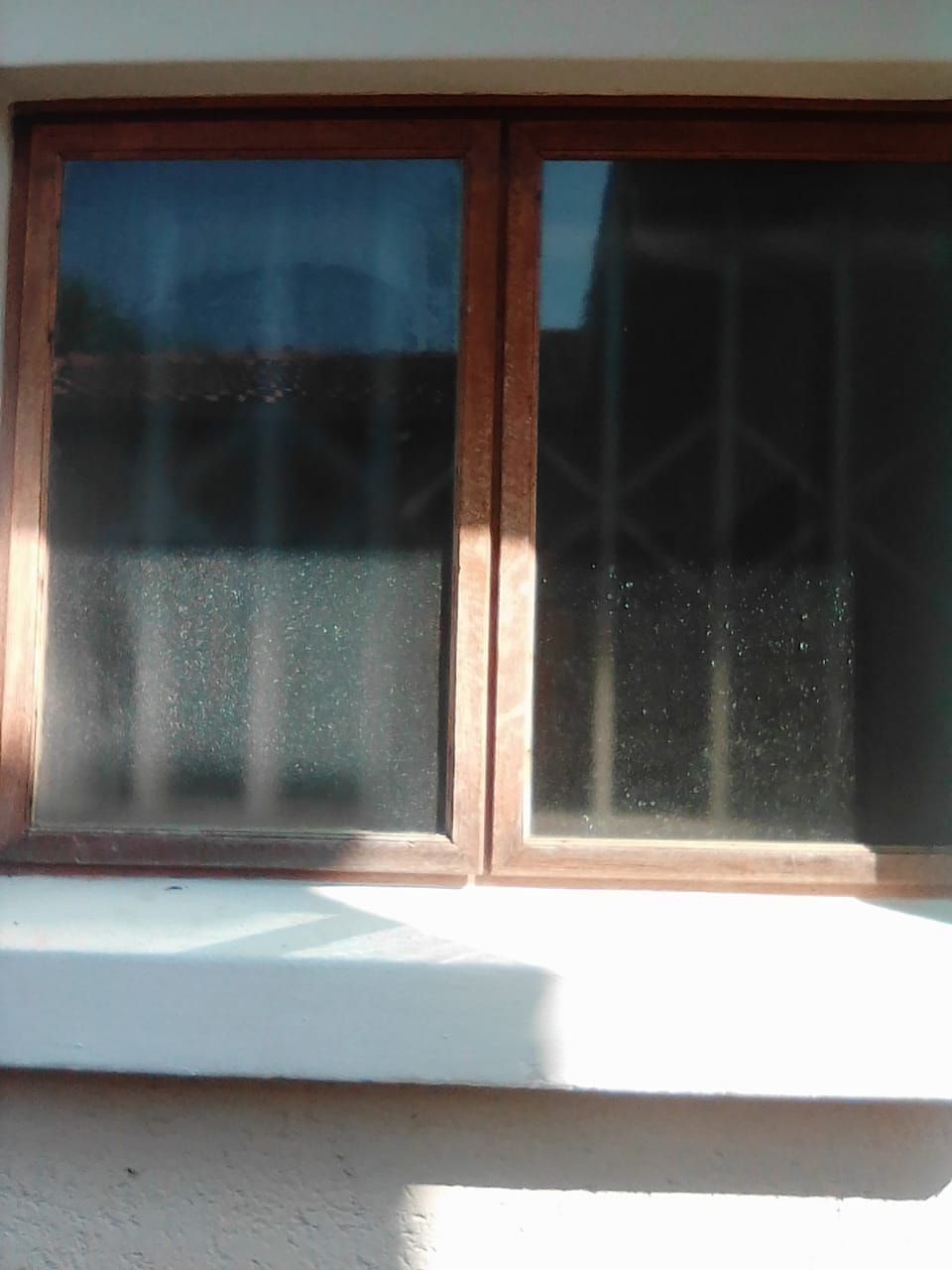 The same wooden window with new glass fitted in both panes